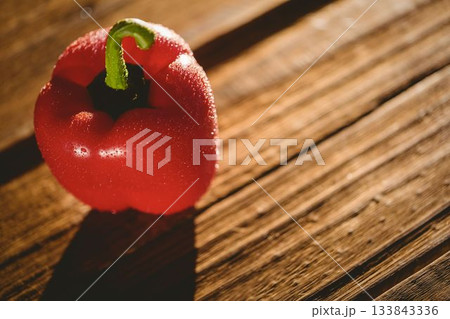Wet red bell pepper on chopping board Wet red bell pepper on chopping board 133843336