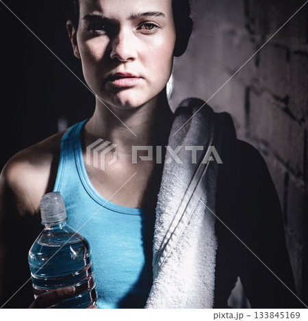 Portrait of confident young woman standing at gym 133845169