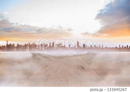 Sandy path leading to large urban city 133845267