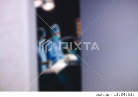 Surgery team operating a patient in an operating room Surgery team operating a patient in an operating room 133845635