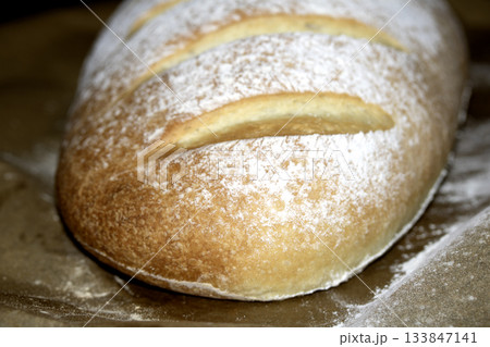 Close up of home made freshly baked bloomer of bread Close up of home made freshly baked bloomer of bread 133847141