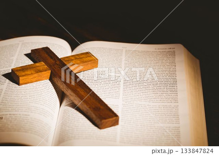 Wooden cross kept on bible 133847824