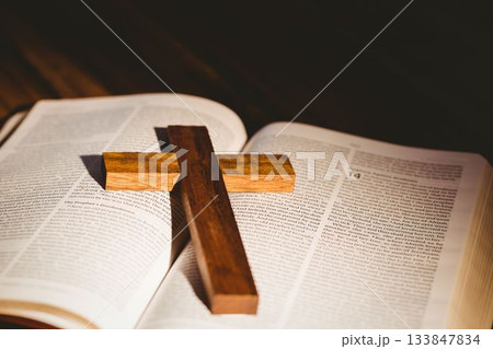 Wooden cross on open bible Wooden cross on open bible 133847834