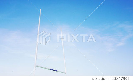Flat design illustration showing rugby goalposts rising against clear blue sky with wispy clouds 133847901