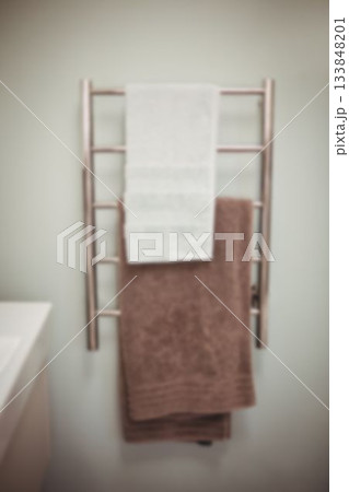Towels hanging on rack in bathroom 133848201