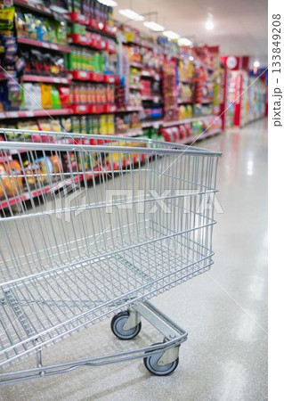 Cropped image of empty shopping cart in aisle 133849208