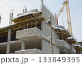 Concrete Structure Rising Through Light Falling Winter Snow 133849395