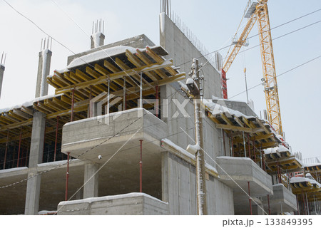 Concrete Structure Rising Through Light Falling Winter Snow Concrete Structure Rising Through Light Falling Winter Snow 133849395