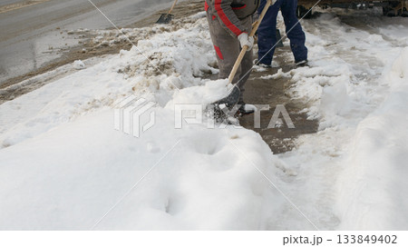 Clearing Snow From Sidewalk During Cold Winter Weather 133849402
