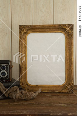 Photo frame and camera on table Photo frame and camera on table 133849531