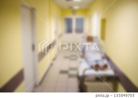 Patient lying on stretcher bed in corridor Patient lying on stretcher bed in corridor 133849703