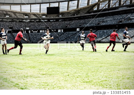 Two teams of rugby players playing rugby in sports stadium Two teams of rugby players playing rugby in sports stadium 133851455