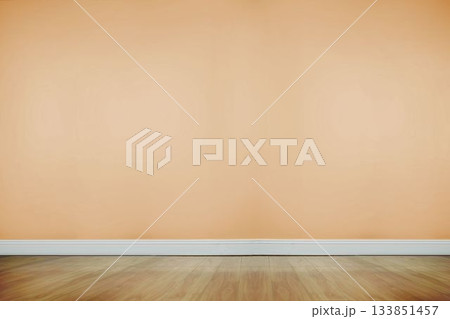 Empty room being shown in flat design, featuring beige wall above white baseboard and wooden floor 133851457