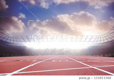 Showing red track lanes with white numbers floodlighting metal-roofed stands under sunlit clouds Showing red track lanes with white numbers floodlighting metal-roofed stands under sunlit clouds 133851560