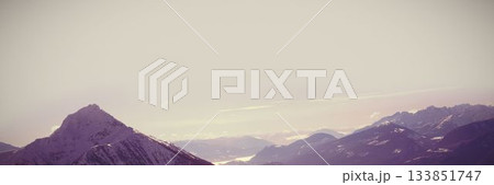 Snow covered mountains during sunset Snow covered mountains during sunset 133851747