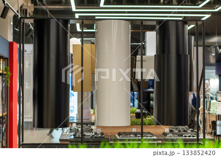 An eye-level shot of modern cylindrical range hoods 133852420