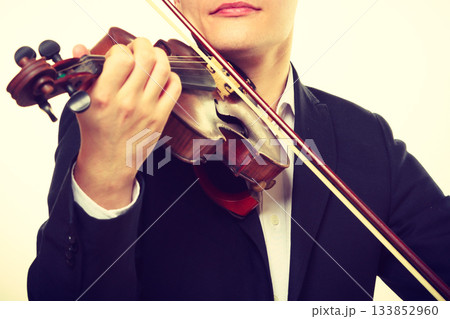 Man man dressed elegantly playing violin Man man dressed elegantly playing violin 133852960