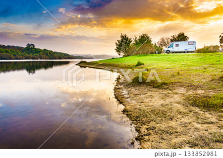 Rv caravan on lake shore at sunset. Autumn time. Rv caravan on lake shore at sunset. Autumn time. 133852981