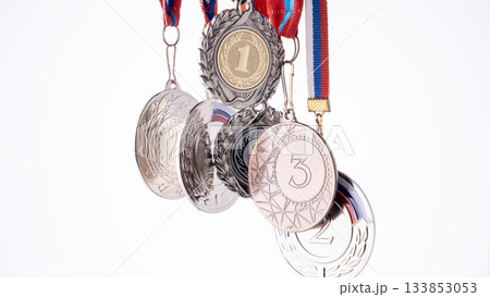 A set of medals, each bearing the numbers 1, 2, and 3. The medals are made of silver and feature a leaf motif. A set of medals, each bearing the numbers 1, 2, and 3. The medals are made of silver and feature a leaf motif. 133853053