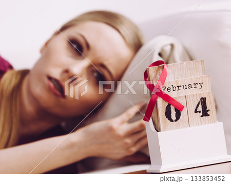 Woman on bed, world breast cancer day on calendar 133853452