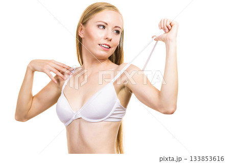 Young woman holding bra strap Young woman holding bra strap 133853616