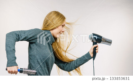 Girl holds hair accessories, styling hair 133853631