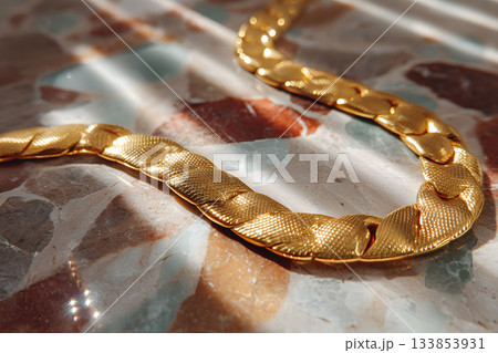 Elegant Gold Chain on Marble Surface Reflecting Sunlight - Jewelry Design Inspiration Generative AI 133853931