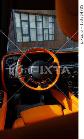 Luxury car interior featuring bold orange accents in a modern setting Luxury car interior featuring bold orange accents in a modern setting 133854785
