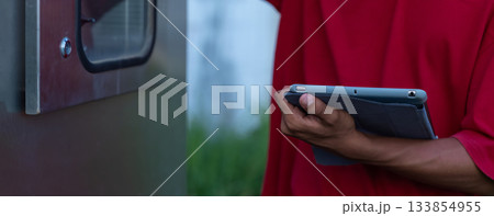 Electrical engineer working in control room.  133854955