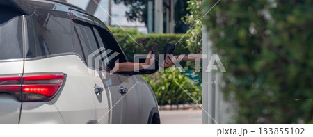 Hand Man in car receiving coffee in drive thru fast food restaurant. 133855102