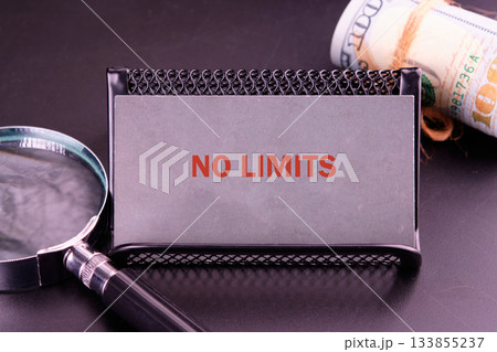 A bold message reading no limits stands out against a textured background, accompanied by a magnifying glass and a rolled banknote, symbolizing ambition and opportunity A bold message reading no limits stands out against a textured background, accompanied by a magnifying glass and a rolled banknote, symbolizing ambition and opportunity 133855237