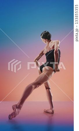Contemporary dancer in dynamic back-lean pose on multicolor gradient 133855355