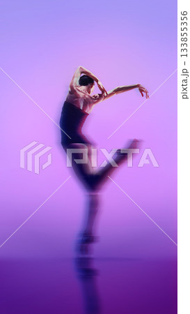 Dancer in blurred expressive motion on purple gradient background. 133855356