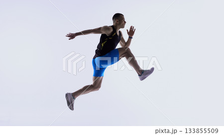 Athlete jumping forward in extended mid-stride.の写真素材 [133855509] - PIXTA