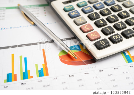 Calculator with pen on data business graphs paper. 133855942
