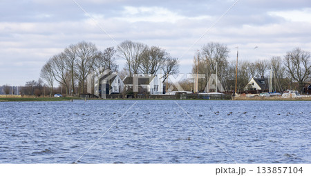 Historical Eemnes pumping station surrounded by flooded meadow in Eempolder, Netherlands 133857104