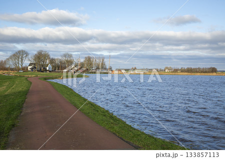 Flooded meadow surrounding Eemnes pumping station in Eempolder, Netherlands during a clear day Flooded meadow surrounding Eemnes pumping station in Eempolder, Netherlands during a clear day 133857113