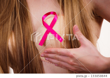 Woman chest in bra, pink cancer ribbon Woman chest in bra, pink cancer ribbon 133858644