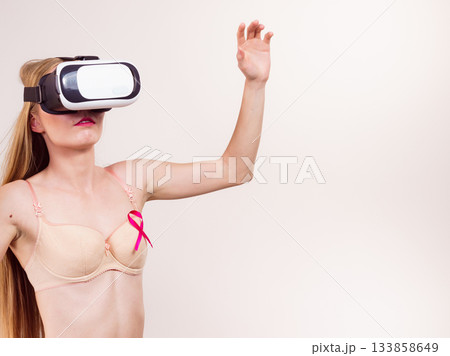 Girl in bra pink cancer ribbon and vr box 133858649