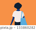 Rear view of a person with curly hair carrying a blue tote bag on an orange background. 133860282
