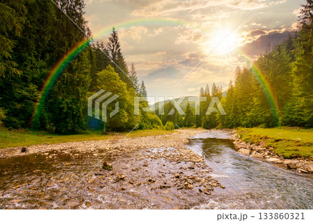 landscape with mountains, forest and a river in front at sunset. beautiful scenery in summer in evening light. water flowing through ecology and sustainability storytelling image under the rainbow landscape with mountains, forest and a river in front at sunset. beautiful scenery in summer in evening light. water flowing through ecology and sustainability storytelling image under the rainbow 133860321
