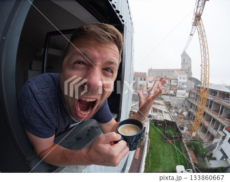 Angry man looking out the window with coffee Angry man looking out the window with coffee 133860667