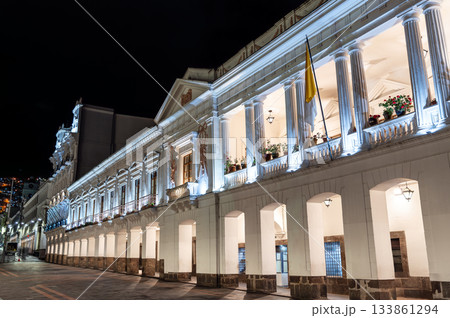 Illuminated Carondelet Palace stands on Independence Square in Quito, Ecuador. Historic presidential seat features white colonial architecture with columns under night sky Illuminated Carondelet Palace stands on Independence Square in Quito, Ecuador. Historic presidential seat features white colonial architecture with columns under night sky 133861294