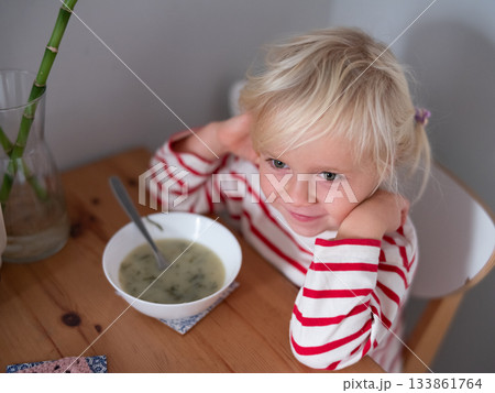 caucasian girl enjoying eating soup caucasian girl enjoying eating soup 133861764
