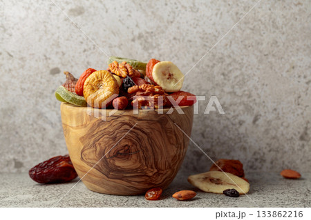 Mix of dried fruits and nuts on a gray stone table. Mix of dried fruits and nuts on a gray stone table. 133862216