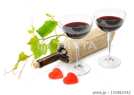Romantic Red Wine Glasses, Grape Vine, and Heart-Shaped Candles 133862542