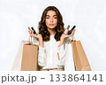 Woman holding makeup and shopping bags shows purchases. 133864141
