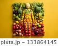 A vegan figure made from fresh fruits and vegetables stands tall. 133864145