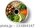 A vegan bowl features rice, tofu, broccoli, avocado, edamame, and carrots. 133864147