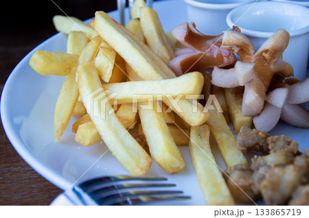Fried French Fries and Fried Sausages Fried French Fries and Fried Sausages 133865719